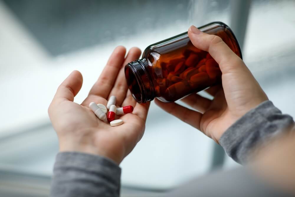 women-pouring-pills-on-her-palm