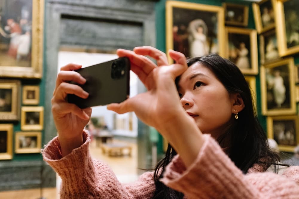 young-woman-taking-picture-at-a-museum