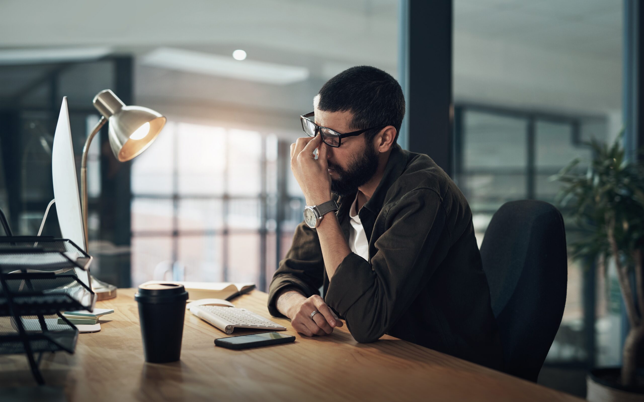 Man experiencing burnout at an office computer